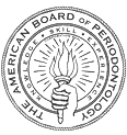 The image shows a circular seal with intricate patterns and text around the edge, featuring a central emblem that appears to be a stylized letter A with a wreath of laurel leaves encircling it.