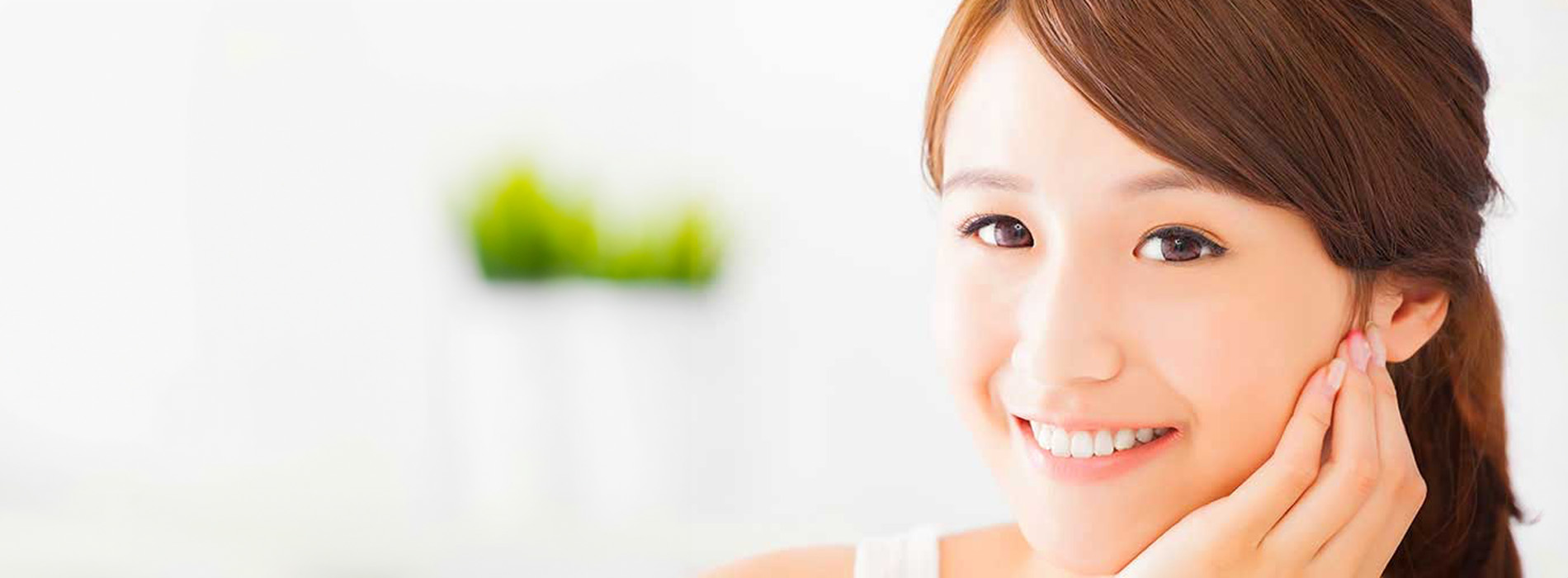 The image shows a woman with a radiant smile looking at the camera, with her face partially obscured by an overlay graphic.